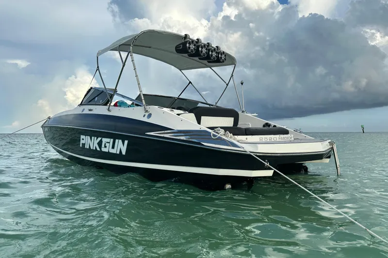 Slide: The Image of 2008 Regal 2520 FasDeck boat named "Pink Gun" anchored on calm water. - 9