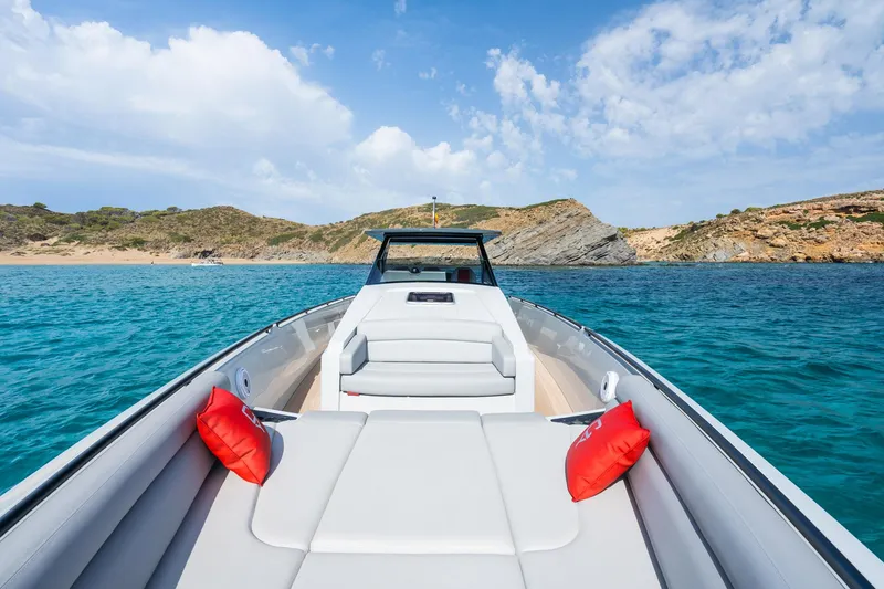 Slide: The Image of 2023 Chaser 54 Laguna boat on turquoise water with scenic coastal backdrop. - 10