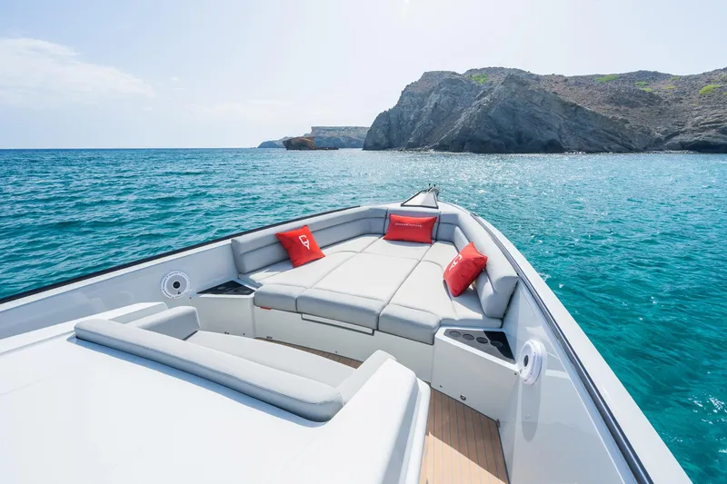 Slide: The Image of Luxurious 2023 Chaser 54 Laguna yacht with sunbathing deck, cruising near rocky coastline. - 11