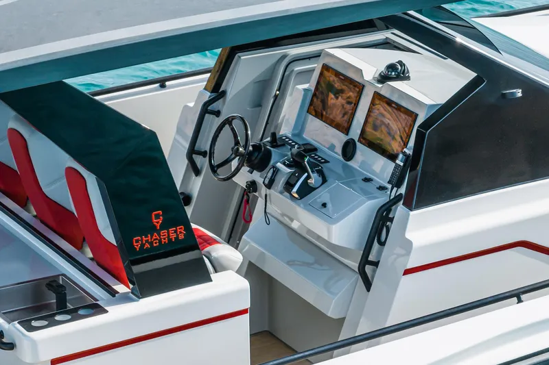 Slide: The Image of 2023 Chaser 54 Laguna yacht cockpit with dual screens and modern controls. - 14