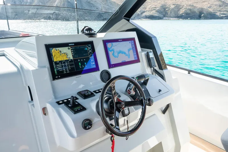Slide: The Image of Modern helm of 2023 Chaser 54 Laguna boat with navigation screens and steering wheel. - 16