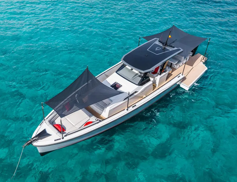 Slide: The Image of 2023 Chaser 54 Laguna yacht on clear turquoise water, featuring sleek design and sunshades. - 2