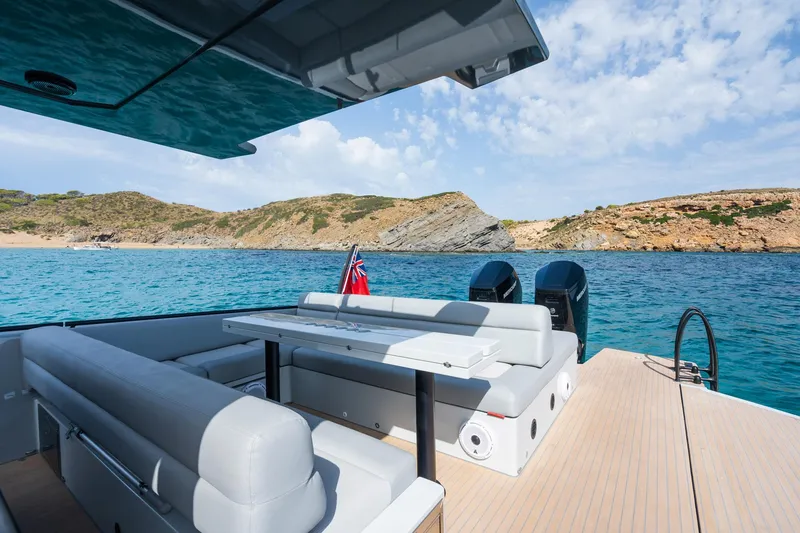 Slide: The Image of 2023 Chaser 54 Laguna yacht on serene blue waters with scenic coastal backdrop. - 23