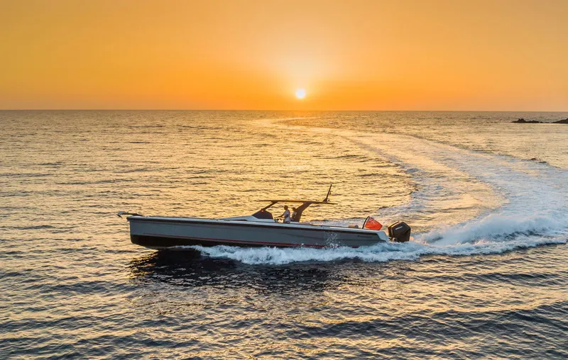 Slide: The Image of 2023 Chaser 54 Laguna boat cruising at sunset on open water. - 41