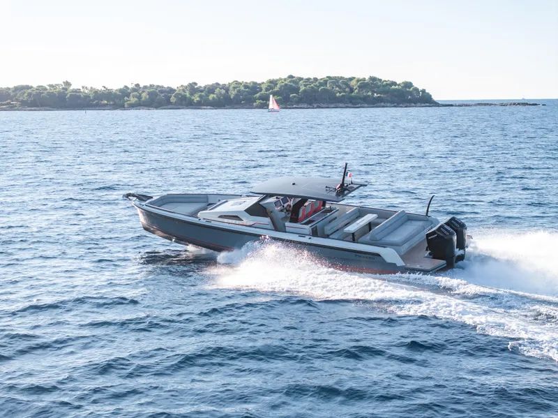 Slide: The Image of 2023 Chaser 54 Laguna boat cruising on open water near a lush island. - 43