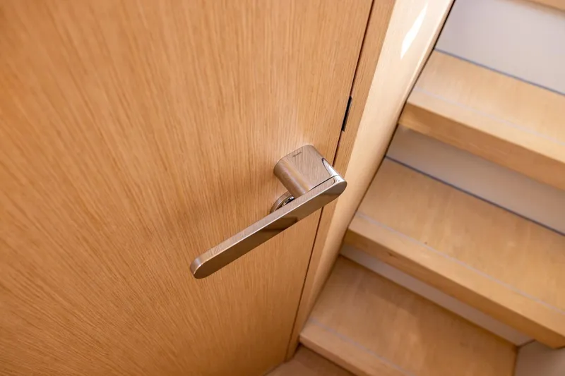 Slide: The Image of Sleek wooden door with modern handle beside stairs on Chaser 54 Laguna, 2025 model. - 5