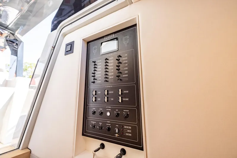 Slide: The Image of Control panel inside 2025 Chaser 54 Laguna yacht, featuring switches and dials. - 7