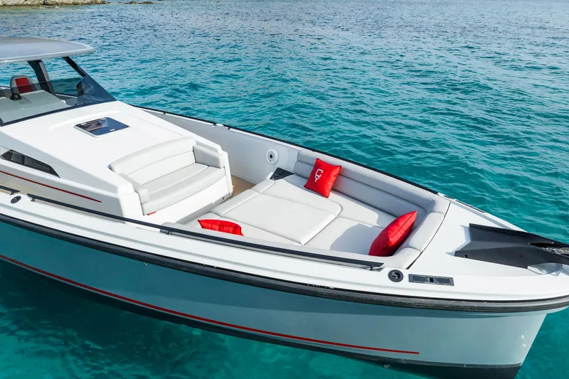 Slide: The Image of 2023 Chaser 54 Laguna boat on clear turquoise water, featuring sleek design and red accents. - 8