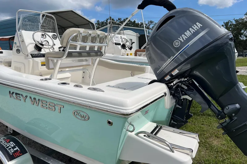 Slide: The Image of 2026 Key West 179 FS boat with Yamaha outboard motor, parked outdoors. - 1