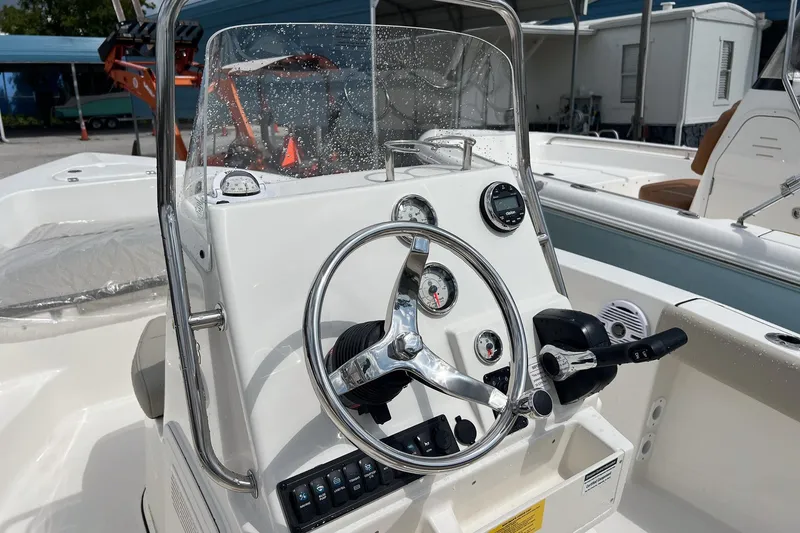 Slide: The Image of 2026 Key West 179 FS boat interior with storage compartments and Yamaha 115 engine. - 5