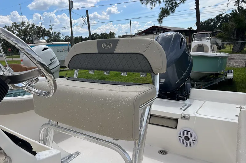 Slide: The Image of 2026 Key West 179 FS boat interior with cushioned seating and console. - 7