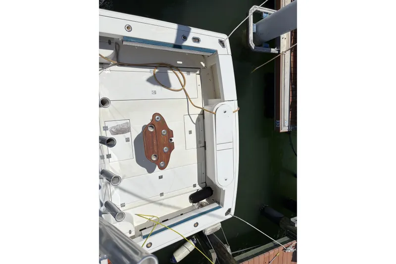 Slide: The Image of 2006 Rampage 38 Express boat docked, aerial view of deck and fishing equipment. - 14