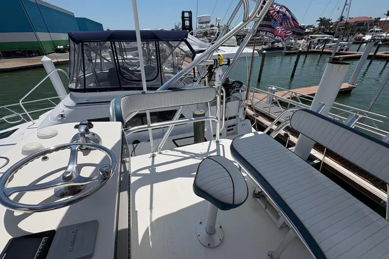 Slide: The Image of 2006 Rampage 38 Express yacht helm with seating, docked at marina. - 21