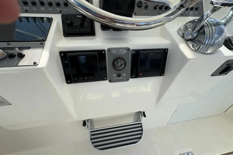Slide: The Image of 2006 Rampage 38 Express helm with Garmin displays and controls. - 25