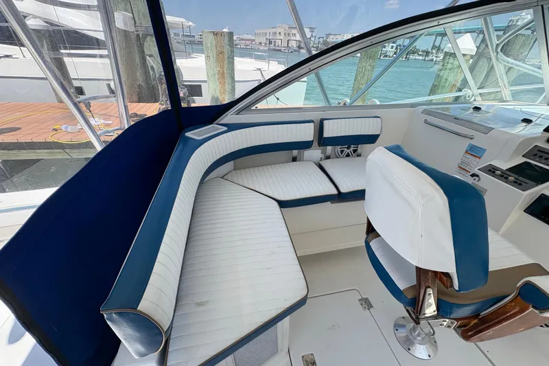 Slide: The Image of 2006 Rampage 38 Express boat interior with blue and white seating, dockside view. - 26