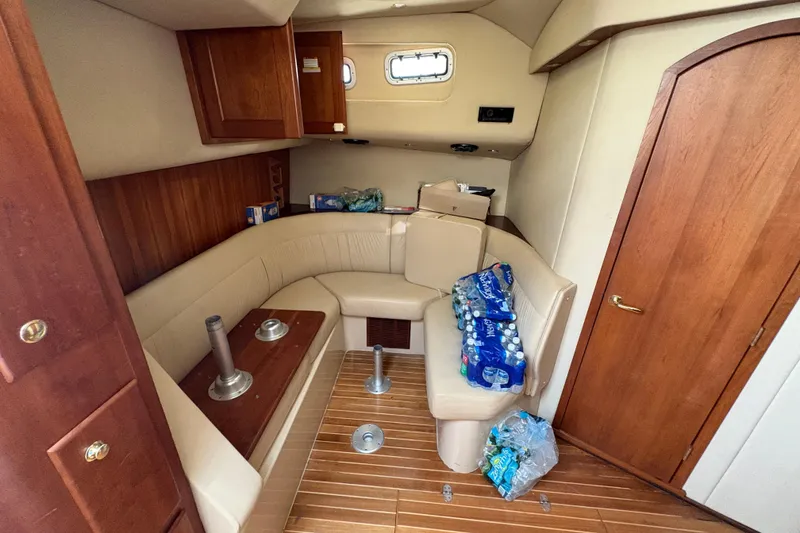 Slide: The Image of 2006 Rampage 38 Express cabin interior with seating and bottled water storage. - 27