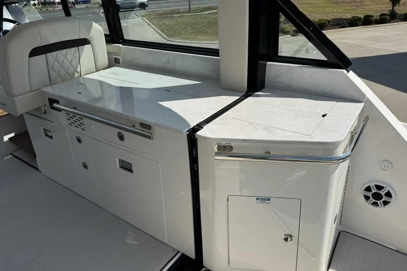 Slide: The Image of 2026 Regal 36 Grande Coupe interior with sleek white cabinetry and seating. - 11