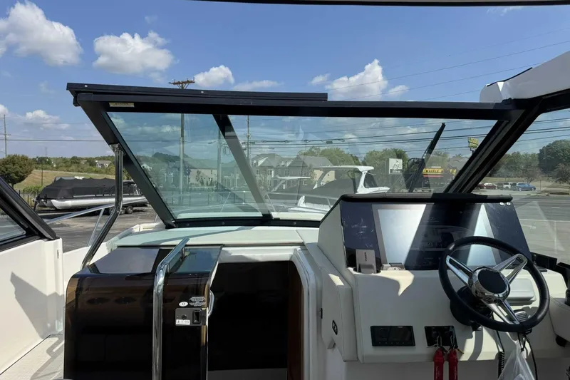 Slide: The Image of 2026 Regal 36 Grande Coupe helm with modern controls and panoramic windshield. - 15