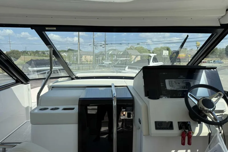 Slide: The Image of Interior view of 2026 Regal 36 Grande Coupe yacht cockpit with modern controls and steering. - 16