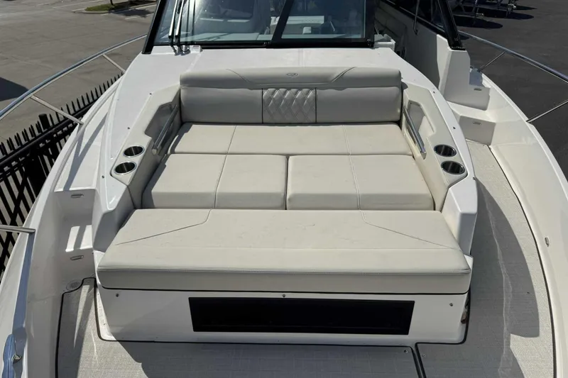 Slide: The Image of 2026 Regal 36 Grande Coupe boat with spacious sunbed and cup holders on deck. - 22