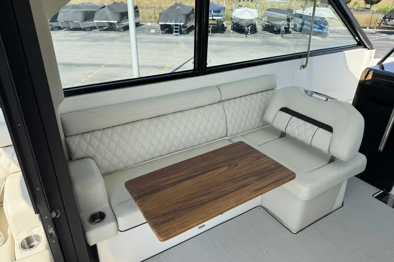 Slide: The Image of Luxurious interior seating of 2026 Regal 36 Grande Coupe with elegant wood table. - 24