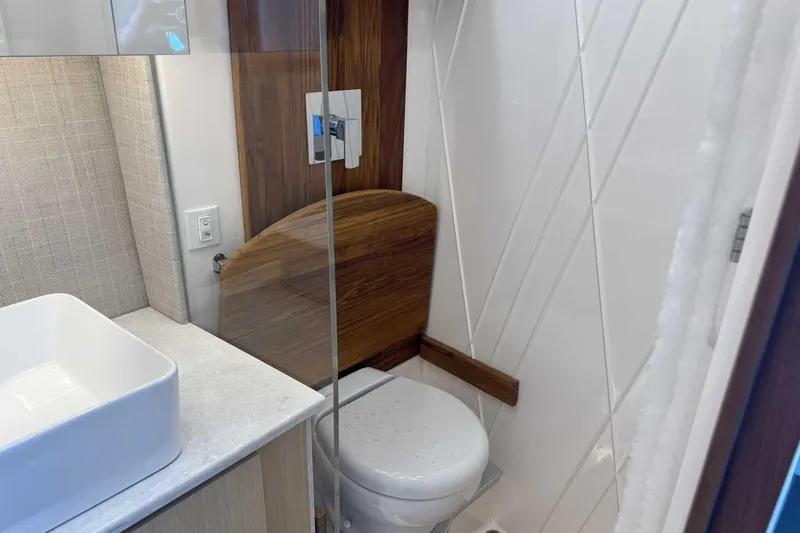 Slide: The Image of Modern bathroom in 2026 Regal 36 Grande Coupe yacht with sleek design and wooden accents. - 26