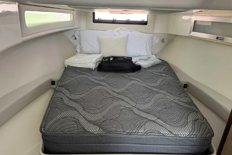 Slide: The Image of Luxurious cabin interior of 2026 Regal 36 Grande Coupe with comfortable bedding. - 29