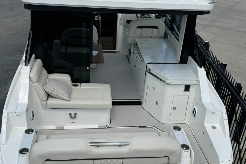 Slide: The Image of 2026 Regal 36 Grande Coupe luxury yacht interior with seating and kitchenette. - 3