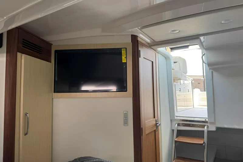 Slide: The Image of Interior of 2026 Regal 36 Grande Coupe with TV and wooden cabinetry. - 33