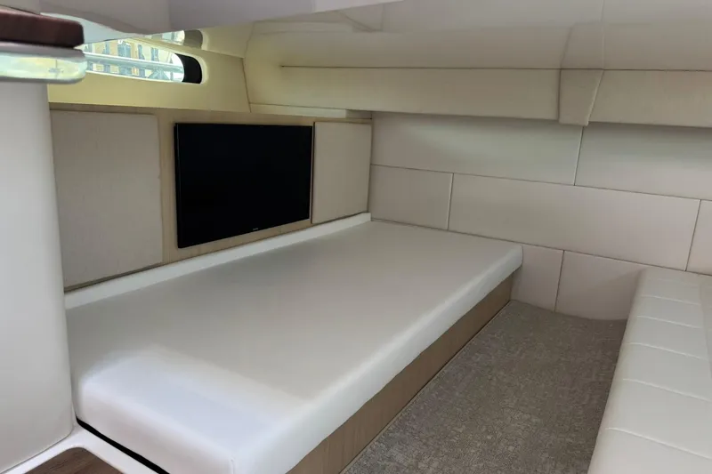 Slide: The Image of Interior cabin of 2026 Regal 36 Grande Coupe, featuring a sleek bed and wall-mounted TV. - 35