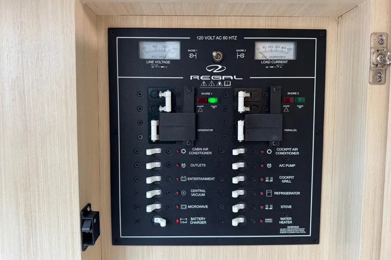 Slide: The Image of Electrical control panel of 2026 Regal 36 Grande Coupe boat, featuring various switches and indicators. - 37