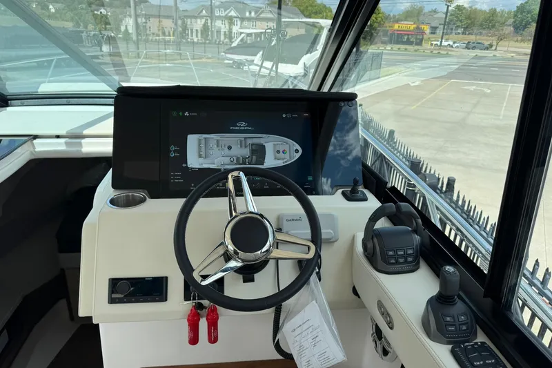 Slide: The Image of 2026 Regal 36 Grande Coupe helm with modern controls and navigation display. - 40