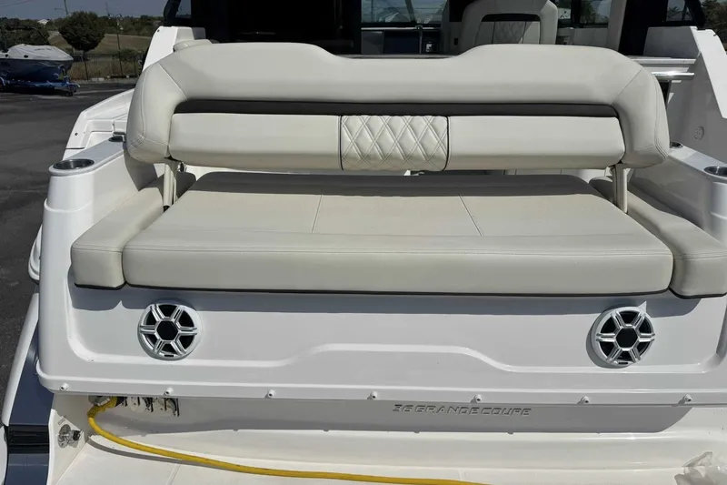 Slide: The Image of 2026 Regal 36 Grande Coupe boat with luxurious rear seating and integrated speakers. - 7