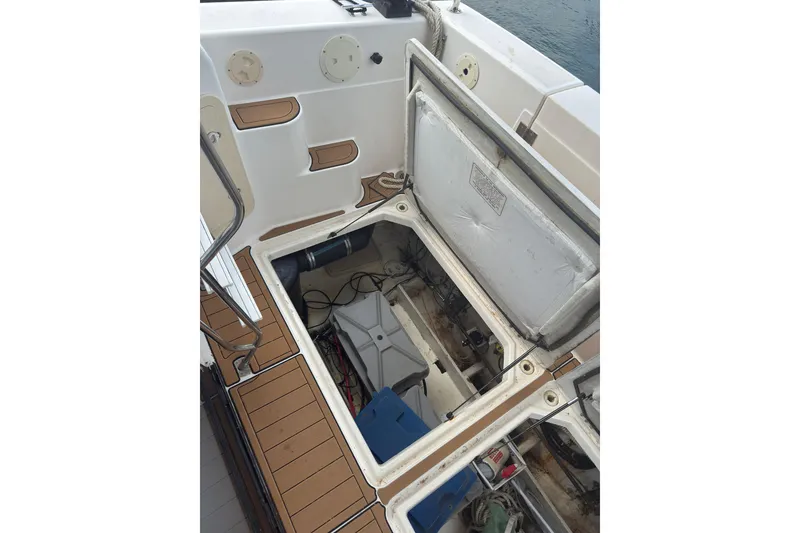 Slide: The Image of Open hatch on 1997 Bayliner 3788 Command Bridge Motoryacht, revealing storage and mechanical components. - 14