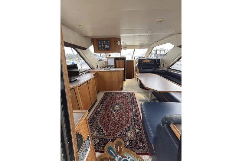 Slide: The Image of Interior of 1997 Bayliner 3788 Command Bridge Motoryacht with wood cabinetry and seating. - 16