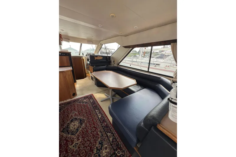 Slide: The Image of Interior of 1997 Bayliner 3788 Command Bridge Motoryacht with seating and table. - 18