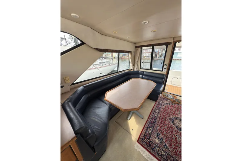 Slide: The Image of Interior of 1997 Bayliner 3788 Command Bridge Motoryacht with leather seating and wooden table. - 24