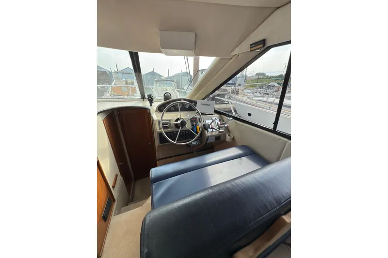 Slide: The Image of 1997 Bayliner 3788 Command Bridge Motoryacht interior helm with steering wheel and navigation equipment. - 25