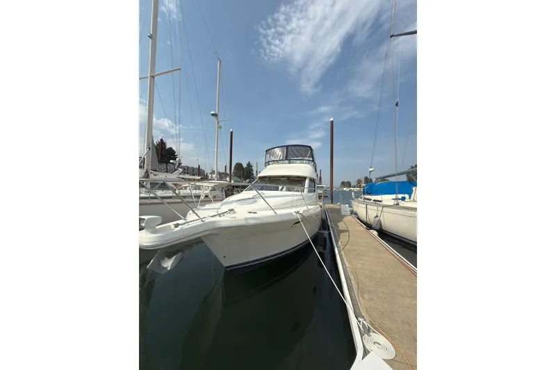 Slide: The Image of 1997 Bayliner 3788 Command Bridge Motoryacht docked at marina under clear sky. - 3