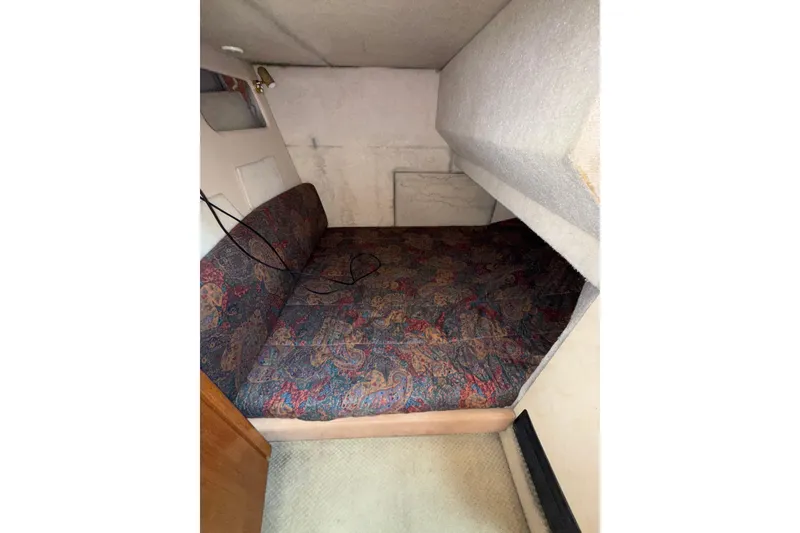 Slide: The Image of 1997 Bayliner 3788 Command Bridge Motoryacht cabin with patterned bedding and cozy interior. - 30