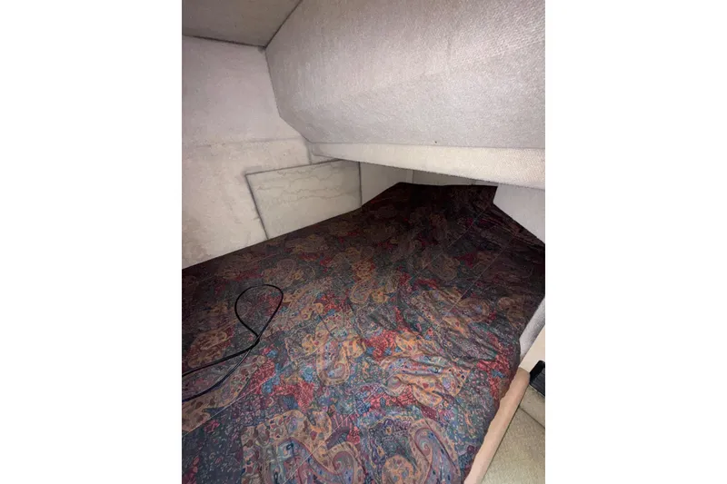 Slide: The Image of Cozy cabin interior of 1997 Bayliner 3788 Command Bridge Motoryacht with patterned bedding. - 31