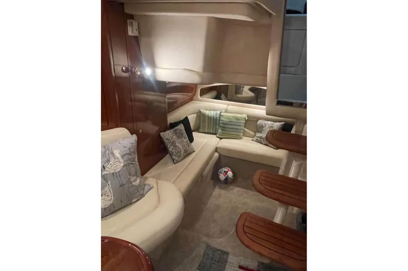 Slide: The Image of Luxurious interior of 2003 Sea Ray 360 Sundancer with plush seating and decorative pillows. - 11