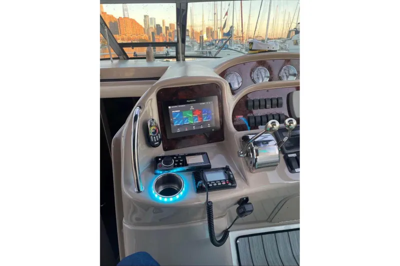 Slide: The Image of Helm of 2003 Sea Ray 360 Sundancer with navigation controls and city skyline view. - 7