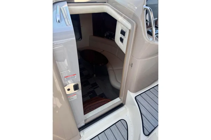 Slide: The Image of 2003 Sea Ray 360 Sundancer cabin entrance with beige interior and seating area. - 8