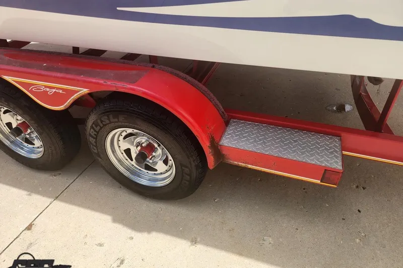 Slide: The Image of Red trailer with dual wheels for 2005 Baja 242 Islander boat. - 11