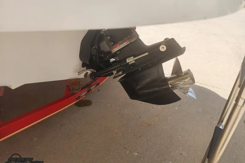 Slide: The Image of 2005 Baja 242 Islander boat propeller and outdrive on a red trailer. - 15