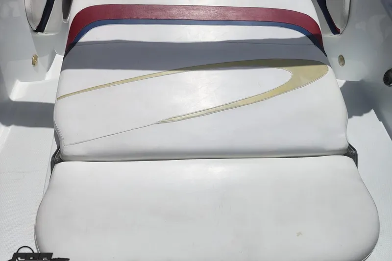 Slide: The Image of 2005 Baja 242 Islander boat seat with white, red, and blue upholstery design. - 21
