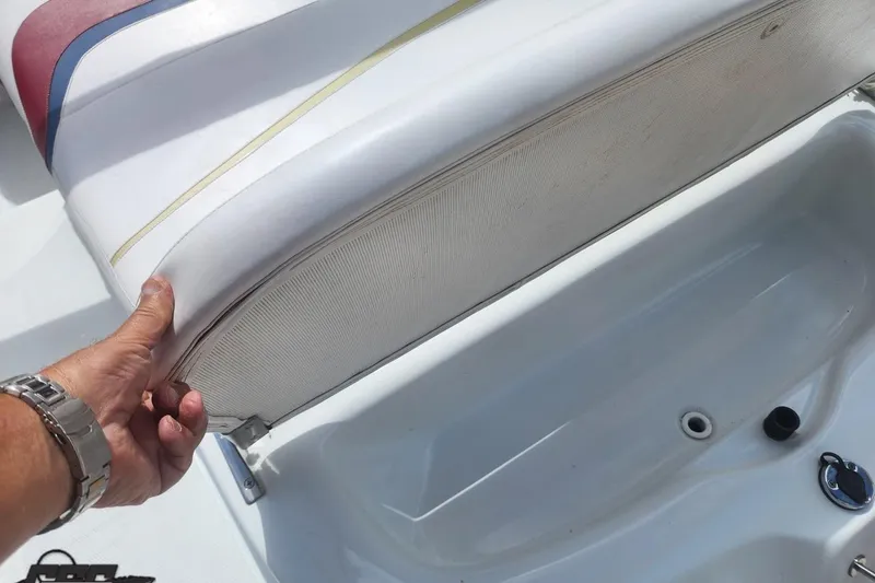Slide: The Image of 2005 Baja 242 Islander boat seat storage compartment being opened. - 23