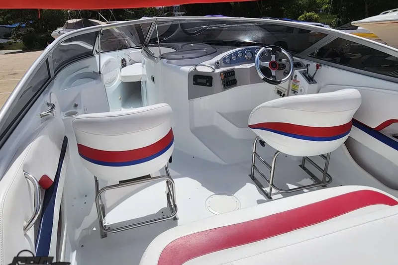 Slide: The Image of 2005 Baja 242 Islander boat interior with white seating and red-blue accents. - 26