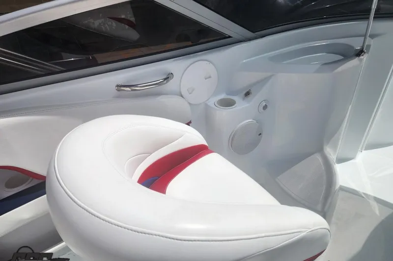Slide: The Image of 2005 Baja 242 Islander boat interior with white and red seating, cup holder, and speaker. - 27